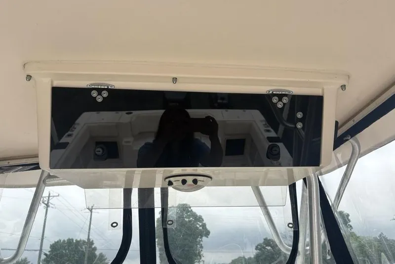 Slide: The Image of 1999 Grady-White Gulfstream 232 boat console with reflective panel and overhead electronics. - 33