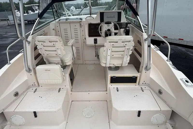 Slide: The Image of 1999 Grady-White Gulfstream 232 boat interior with dual seats and Garmin navigation system. - 11