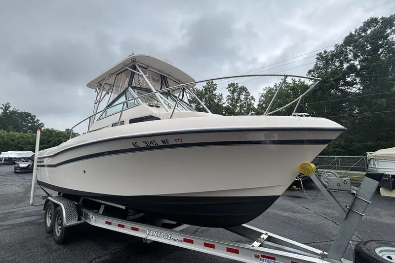 Slide: The Image of 1999 Grady-White Gulfstream 232 boat on trailer, parked outdoors under cloudy sky. - 4