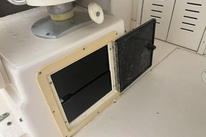 Slide: The Image of Open storage compartment on a 1999 Grady-White Gulfstream 232 boat interior. - 26