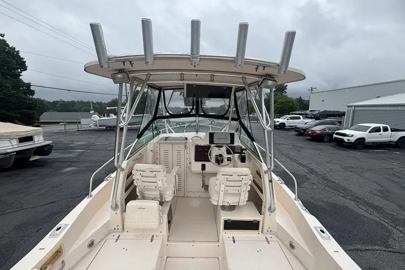 Slide: The Image of 1999 Grady-White Gulfstream 232 boat interior with helm, seats, and rod holders. - 30