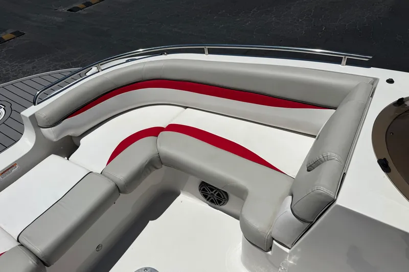 Slide: The Image of 2021 Starcraft MDX 211 O/B boat interior with gray and red cushioned seating. - 15