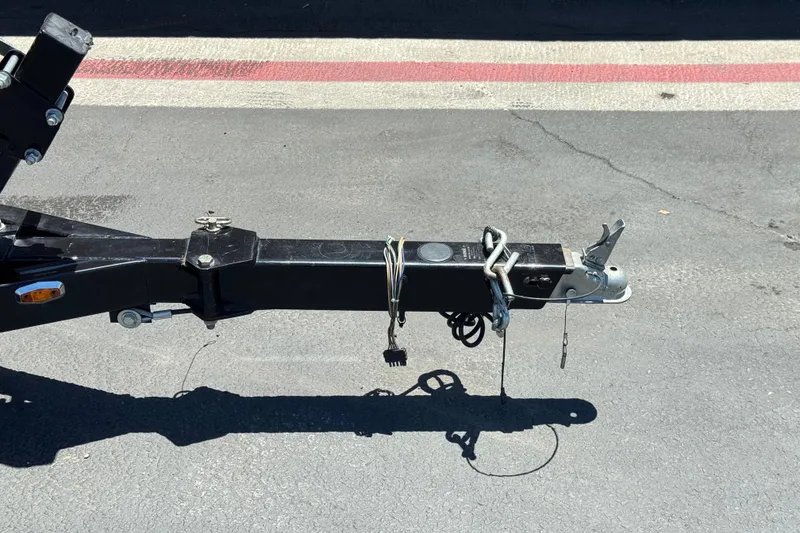 Slide: The Image of Trailer hitch of a 2021 Starcraft MDX 211 O/B on asphalt pavement. - 34