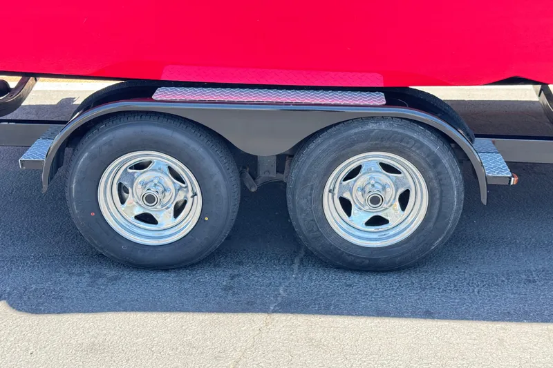 Slide: The Image of Trailer wheels of a 2021 Starcraft MDX 211 O/B boat on pavement. - 33