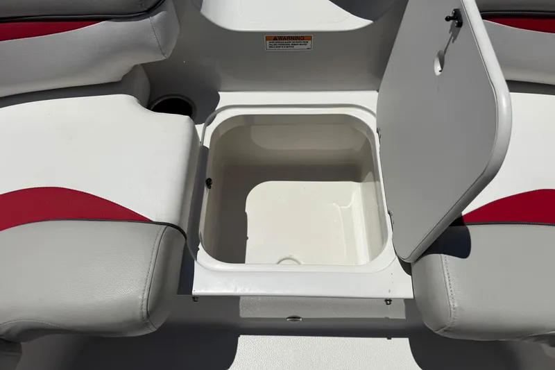 Slide: The Image of Open storage compartment on 2021 Starcraft MDX 211 O/B boat with red and gray seating. - 16