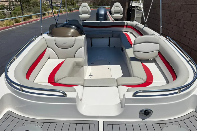 Slide: The Image of 2021 Starcraft MDX 211 O/B boat interior with gray and red seating, spacious layout. - 11