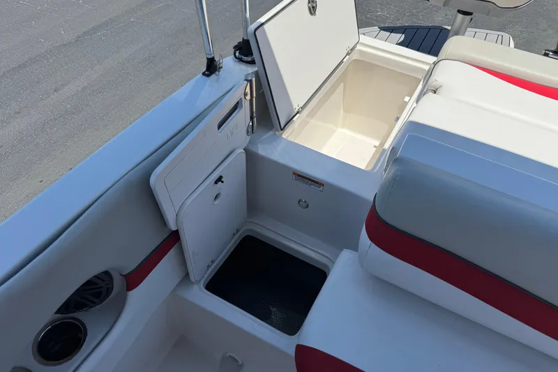 Slide: The Image of Interior view of 2021 Starcraft MDX 211 O/B boat with open storage compartments. - 22