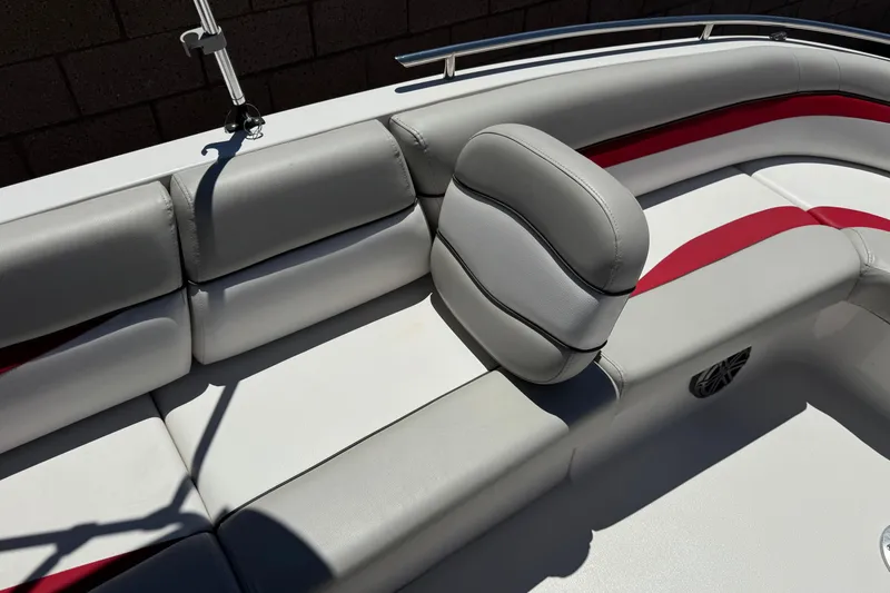 Slide: The Image of 2021 Starcraft MDX 211 O/B boat interior with gray and red cushioned seating. - 14