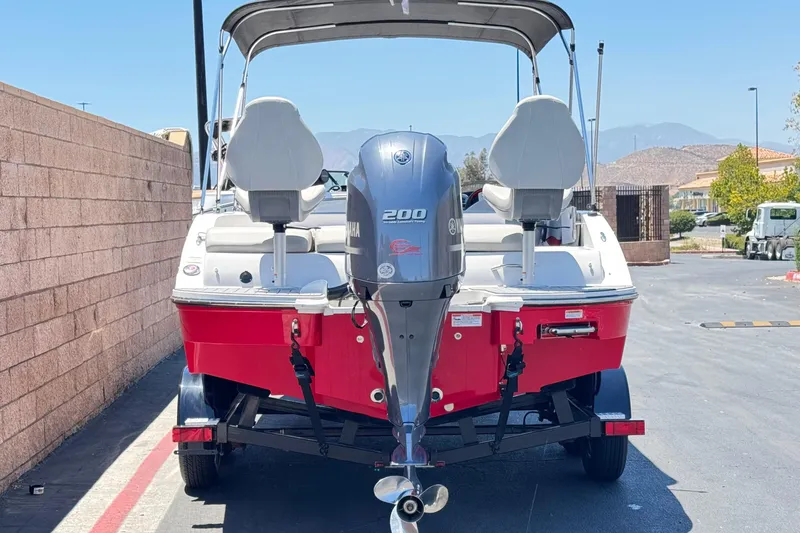 Slide: The Image of 2021 Starcraft MDX 211 O/B boat with Yamaha 200 engine, parked outdoors. - 4