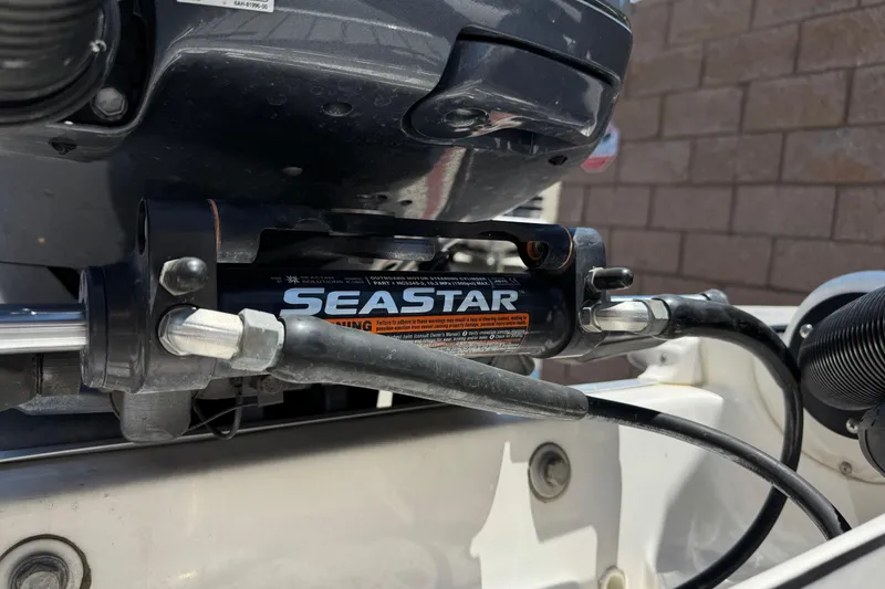 Slide: The Image of Close-up of SeaStar hydraulic steering system on 2021 Starcraft MDX 211 O/B boat. - 7