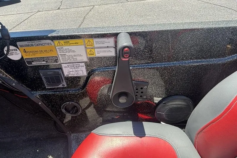 Slide: The Image of Control panel of a 1996 Javelin 369 SDC boat with capacity warnings and throttle lever. - 14