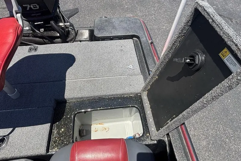 Slide: The Image of Open storage compartment on a 1996 Javelin 369 SDC boat with red seating. - 19