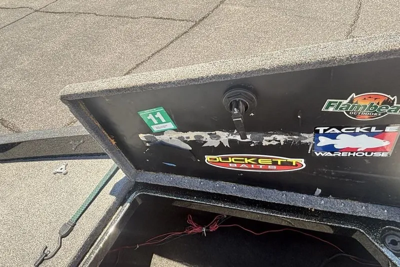 Slide: The Image of Storage compartment of a 1996 Javelin 369 SDC boat with fishing brand stickers. - 9