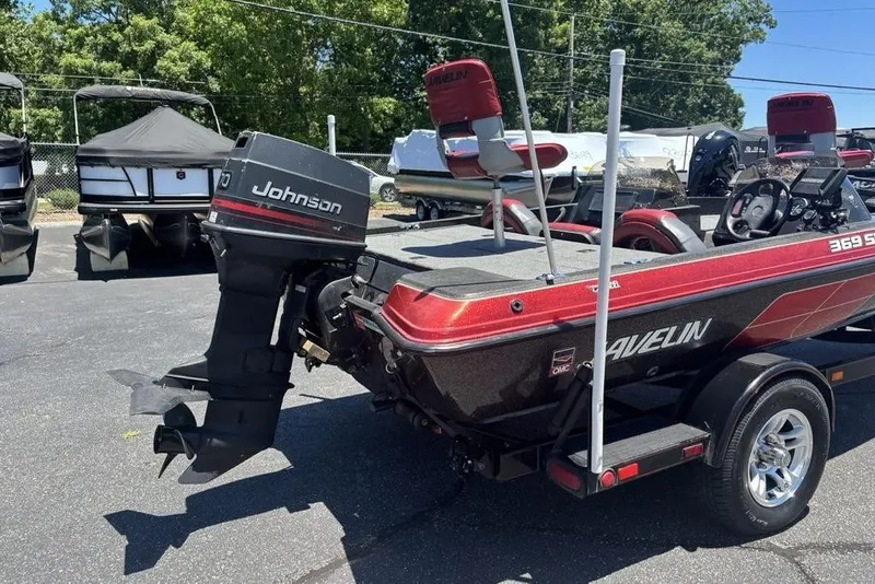 Slide: The Image of 1996 Javelin 369 SDC boat with Johnson outboard motor, parked outdoors. - 3