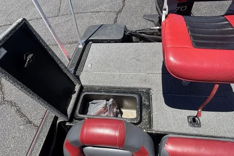 Slide: The Image of Open storage compartment on a 1996 Javelin 369 SDC boat with red and black seating. - 13