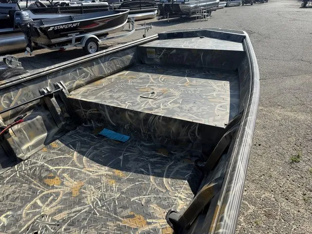 Slide: The Image of A War Eagle 648LDV boat with camouflage pattern, parked on a lot. - 5
