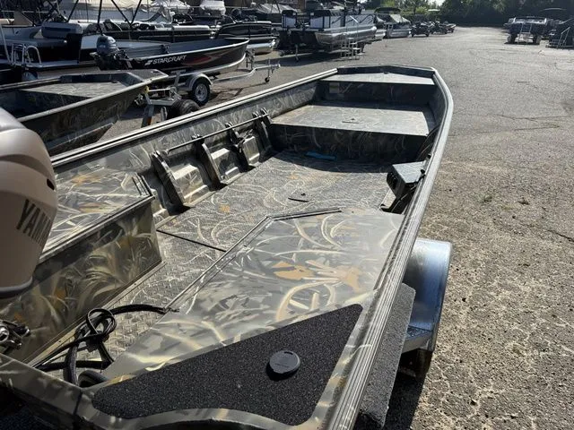 Slide: The Image of A 2026 War Eagle 648LDV boat with camo interior, parked on a trailer. - 6