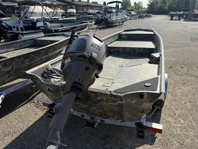Slide: The Image of A 2026 War Eagle 648LDV boat with an outboard motor, parked on a trailer. - 8
