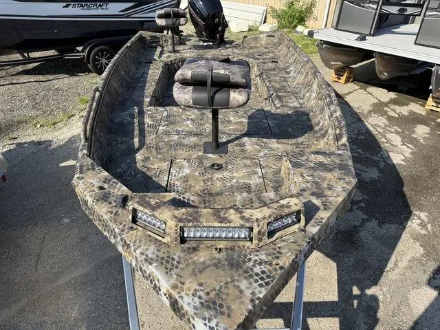 Slide: The Image of The image shows a 2026 Excel Tomahawk 183 T boat with camouflage pattern and LED lights. - 4