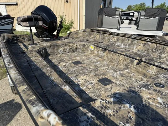 Slide: The Image of The image shows an Excel Tomahawk 183 T boat from 2026 with a camouflaged deck. - 6