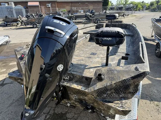 Slide: The Image of An Excel Tomahawk 183 T boat from 2026 with a powerful outboard motor, parked on a trailer. - 9