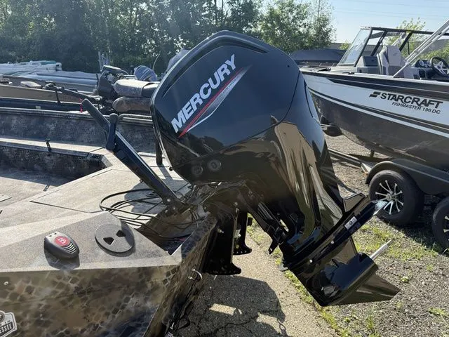 Slide: The Image of An Excel Tomahawk 183 T boat with a Mercury outboard motor, parked on a gravel lot. - 8