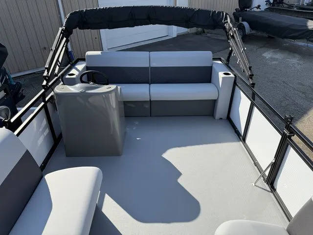 Slide: The Image of The image shows the deck of a 2026 Angler Quest 7515 Leisure Cruise boat with seating and a helm. - 4