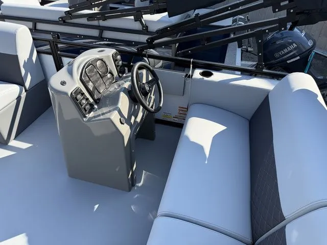 Slide: The Image of The image shows the cockpit of a 2026 Angler Quest 7515 Leisure Cruise boat with gray upholstery. - 5