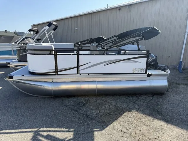 The Image of A 2026 Angler Quest 7515 Leisure Cruise pontoon boat is parked. It features a white railing and black accents. - 1