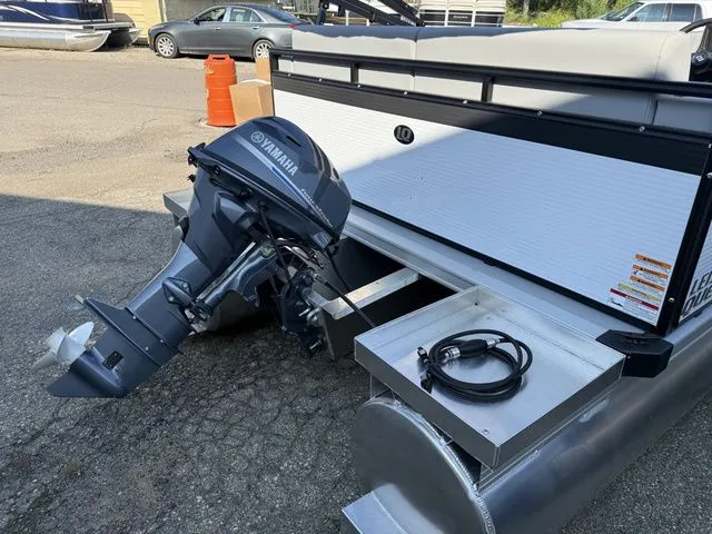 Slide: The Image of An Angler Quest 7515 Leisure Cruise pontoon boat with a Yamaha outboard motor, parked in a lot. - 8