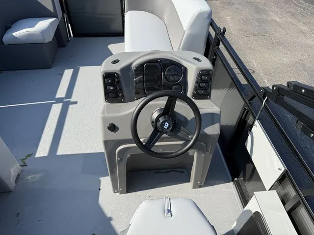 Slide: The Image of The image shows the helm of a 2026 Angler Quest 7515 Leisure Cruise boat. - 7
