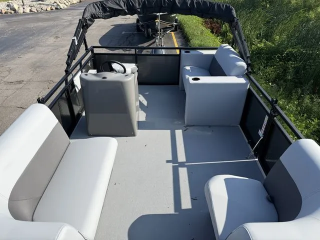 Slide: The Image of The image shows a 2026 Angler Quest 7515 Leisure Cruise boat with gray seating and a helm station. - 4