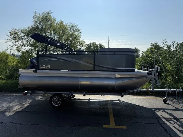 The Image of An Angler Quest 7515 Leisure Cruise pontoon boat on a trailer, surrounded by trees. - 1
