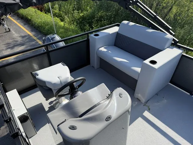 Slide: The Image of The image shows the cockpit of a 2026 Angler Quest 7515 Leisure Cruise boat with gray seating. - 5