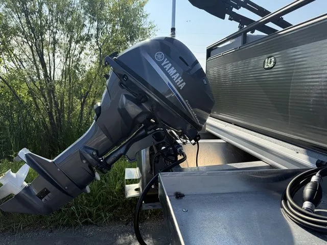 Slide: The Image of A Yamaha outboard motor is mounted on an Angler Quest 7515 Leisure Cruise boat. Trees are visible in the background. - 8