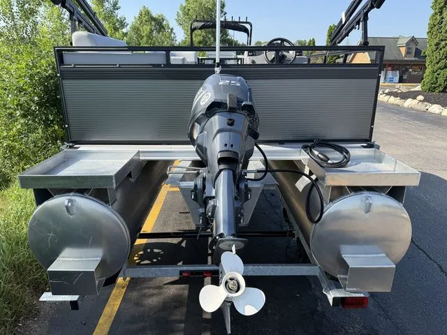 Slide: The Image of The image shows the rear of an Angler Quest 7515 Leisure Cruise pontoon boat with an outboard motor. - 9