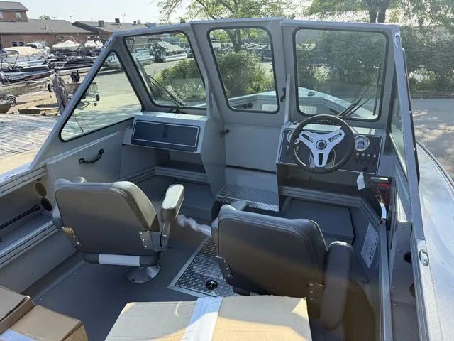 Slide: The Image of The image shows the cockpit of a 2027 Smoker Craft Phantom 18 X2 with two seats and a steering wheel. - 5