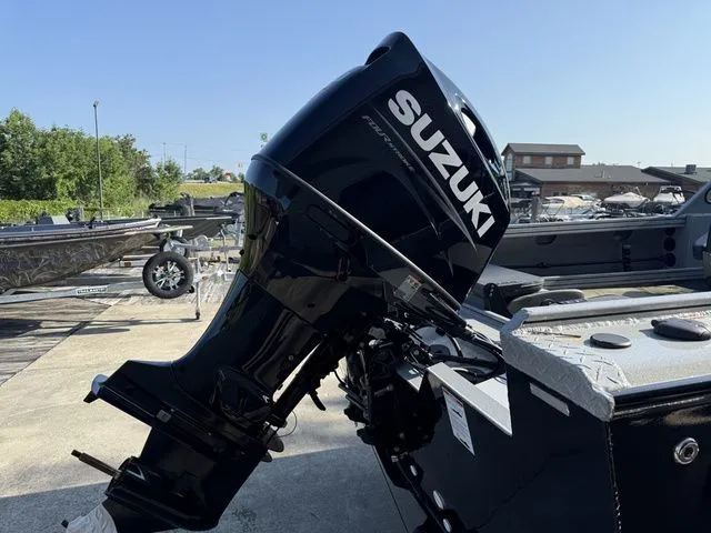 Slide: The Image of A Suzuki outboard motor is mounted on a Smoker Craft Phantom 18 X2 boat, sitting on a trailer. - 8