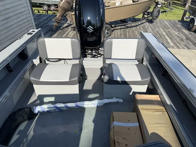Slide: The Image of The image shows the interior of a Smoker Craft Phantom 18 X2 boat with two gray seats. - 6