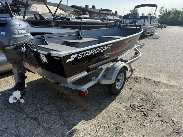 Slide: The Image of A 2027 Starcraft Seafarer DLX 14 boat on a trailer in an outdoor lot. - 3