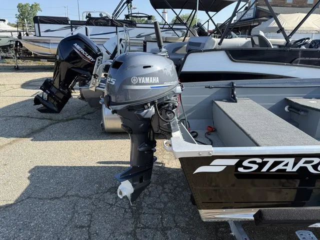 Slide: The Image of A Starcraft Seafarer DLX 14 boat with a Yamaha outboard motor. It is parked on a lot. - 7