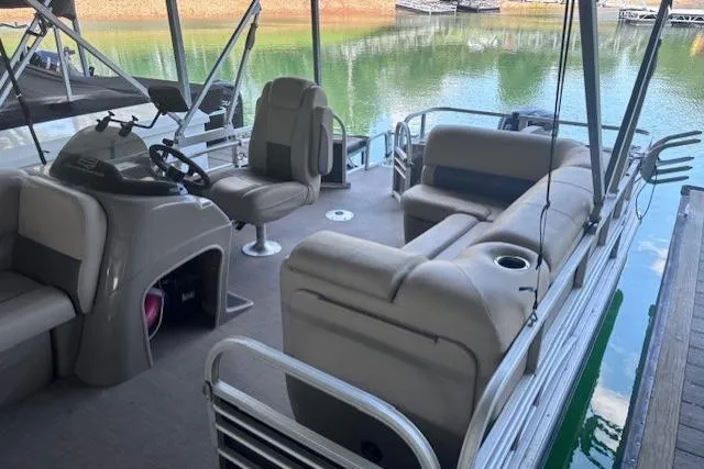 Slide: The Image of 2020 Sun Tracker Fishin' Barge 20 DLX pontoon boat interior with seating and steering console. - 2