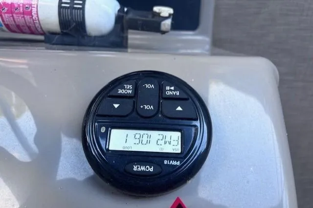 Slide: The Image of Close-up of a 2020 Sun Tracker Fishin' Barge 20 DLX radio control panel. - 19