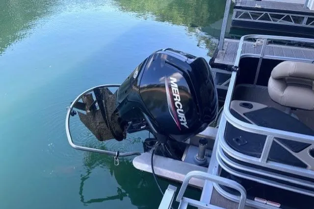 Slide: The Image of 2020 Sun Tracker Fishin' Barge 20 DLX with Mercury outboard motor on calm water. - 6