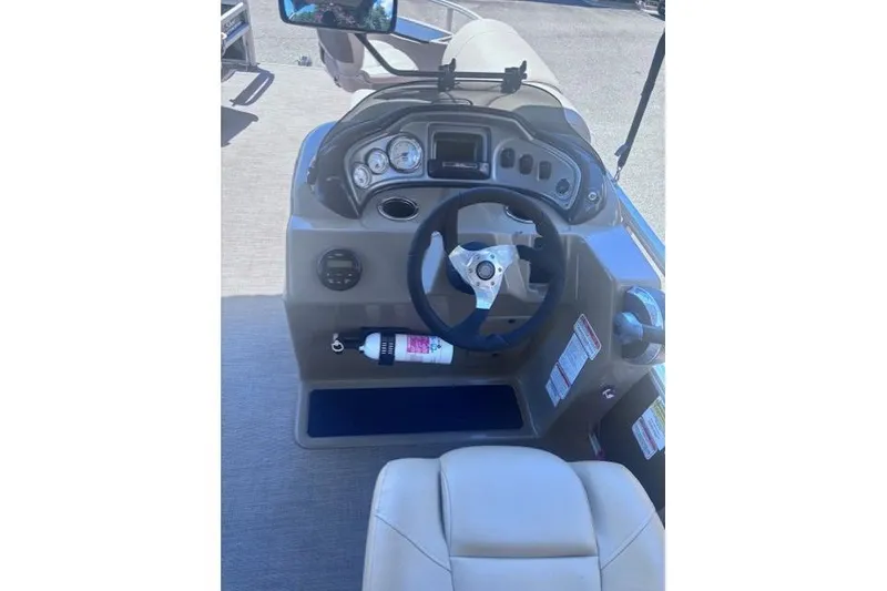Slide: The Image of 2021 Sun Tracker Fishin' Barge 20 DLX helm with steering wheel and gauges. - 62