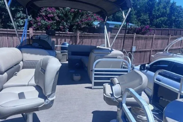 Slide: The Image of 2021 Sun Tracker Fishin' Barge 20 DLX with spacious seating and canopy in a backyard setting. - 24