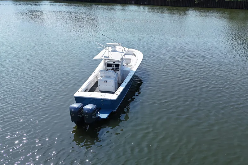 Slide: The Image of 2010 Regulator 34SS on calm water with dual outboard engines. - 7