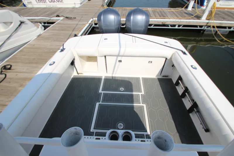 Slide: The Image of The image shows the cockpit of a 2010 Regulator 34SS boat with two outboard engines. - 27