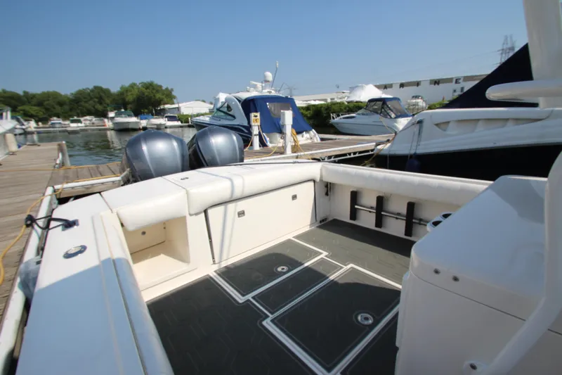 Slide: The Image of The image shows the cockpit of a 2010 Regulator 34SS boat docked at a marina. - 29