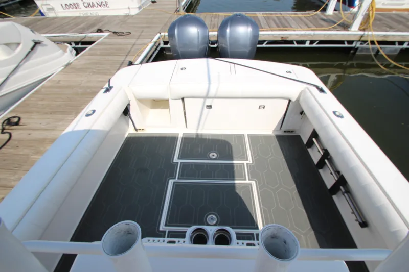 Slide: The Image of The image shows the stern of a 2010 Regulator 34SS boat with twin outboard engines. - 28